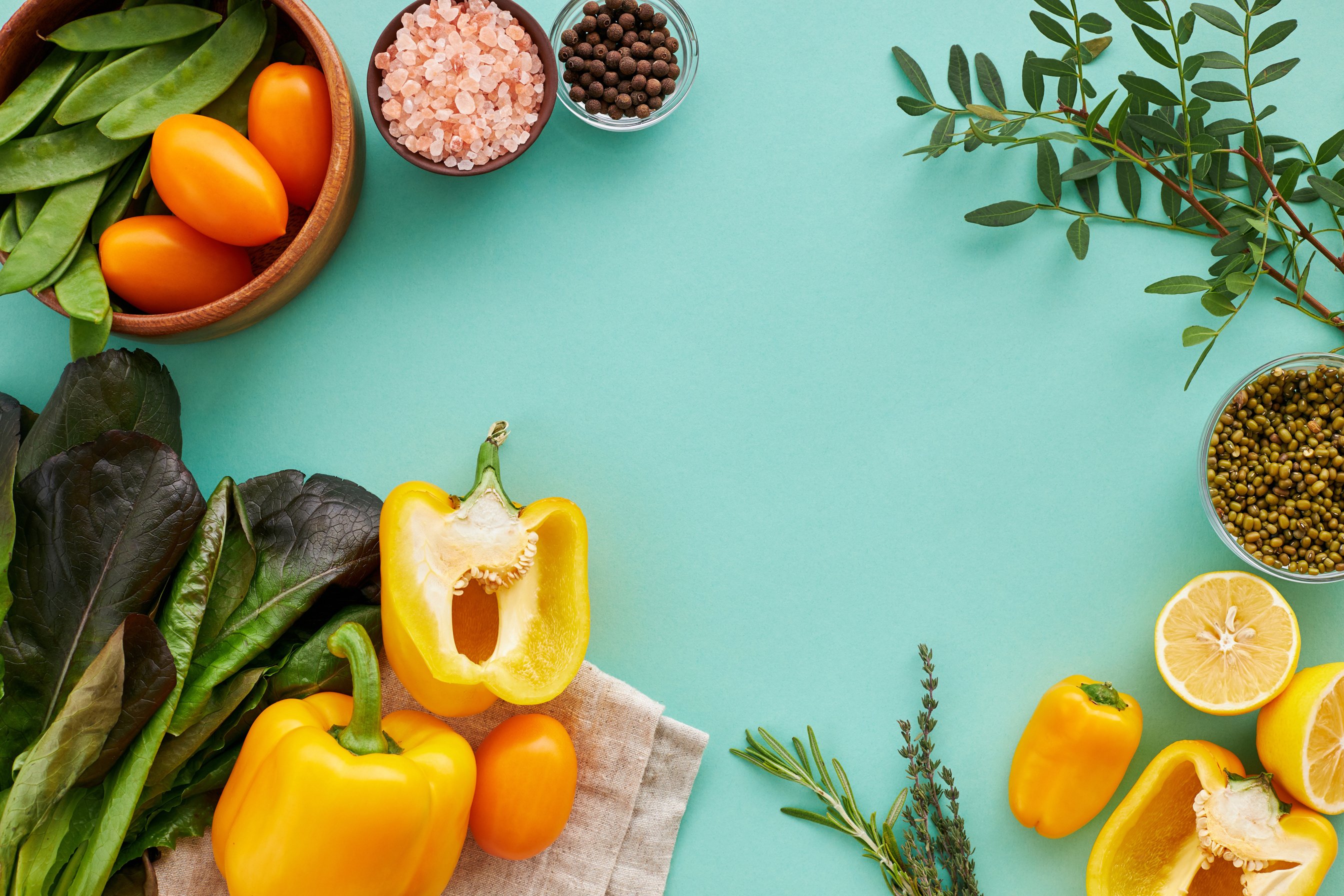 Fresh Fruits and Vegetables on a Teal Background